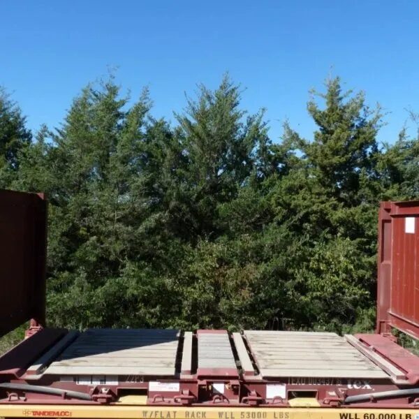 Yard crane lowering a shipping container onto a waiting truck bed
