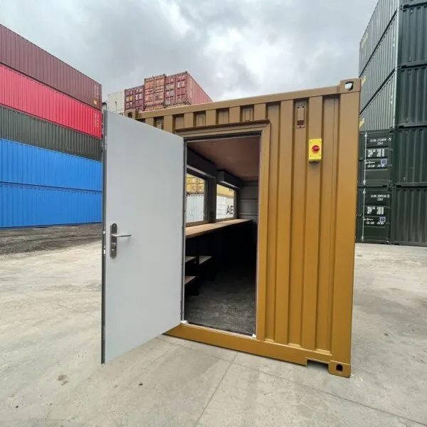Container converted to a site office with a window and personnel door